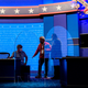 Workers install plexiglass protections between the debaters on the stage of the debate hall ahead of the vice presidential debate in Kingsbury Hall of the University of Utah October 6, 2020 in Salt Lake City, Utah.